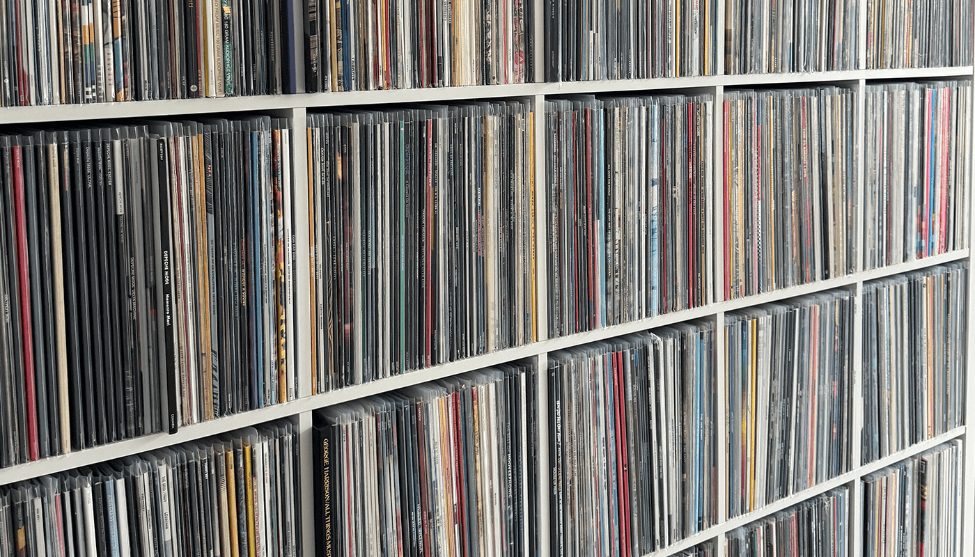 A wall of vinyl records in a home office setting